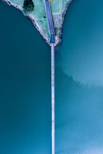 High angle view of sea shore against blue sky