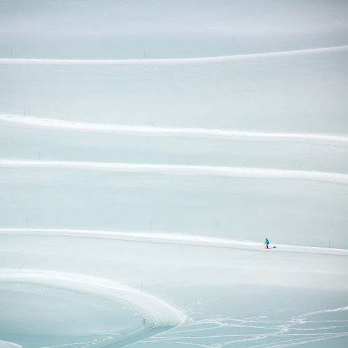 Aerial view of person snowboarding on snow