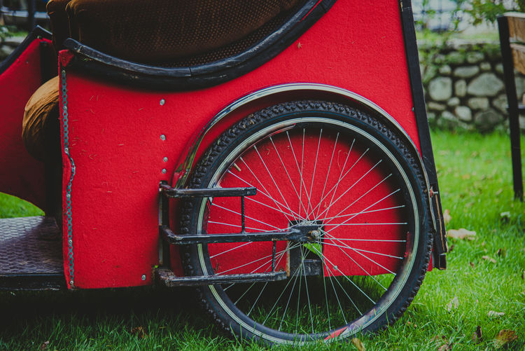 Close-up of red bicycle in field