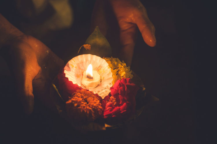 Hindu ceremony in varanasi, the holy city, with flowers and candles floating down the ganges river.