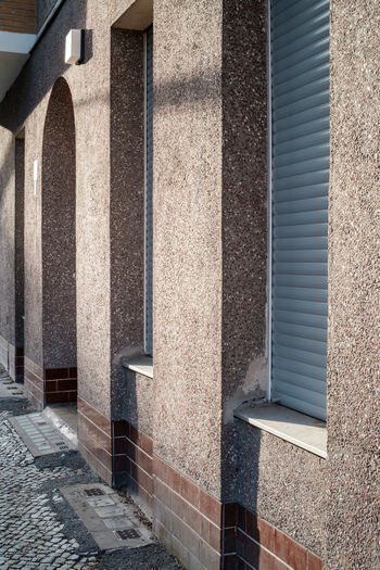 Walls and shuttered doors and windows on a sunny afternoon in the neukölln area of berlin, germany.