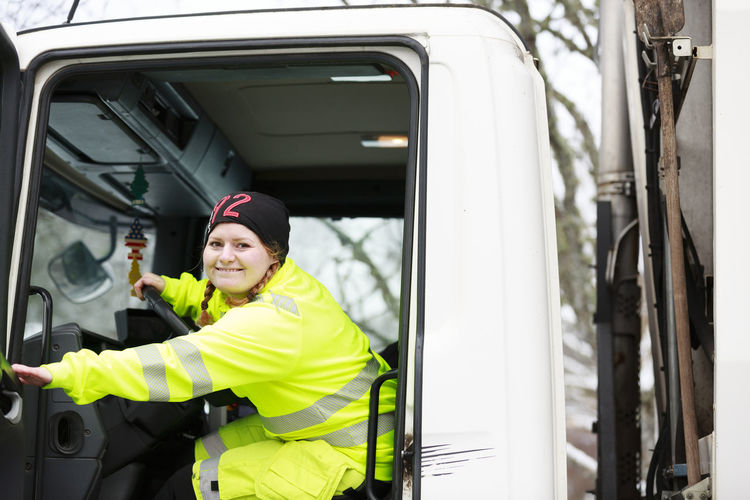Woman in garbage truck cabin