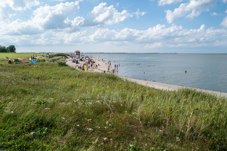 People on beach against sky