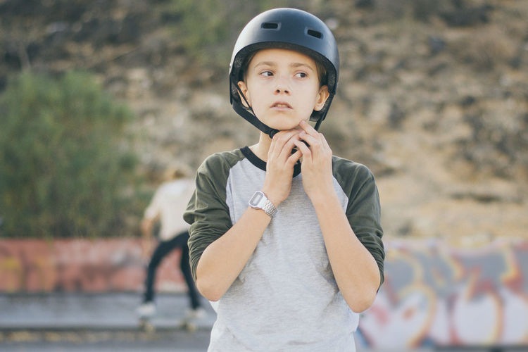 Boy wearing crash helmet outdoors