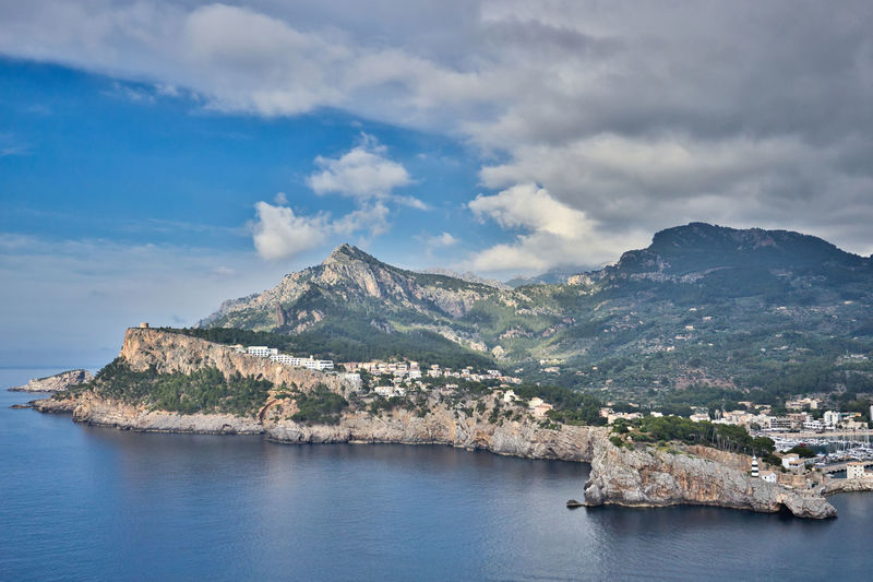 Scenic view of sea and mountains against sky