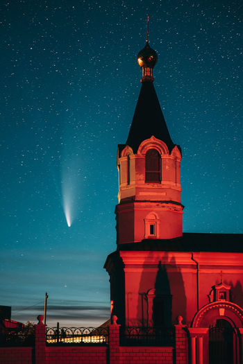Low angle view of illuminated building against sky at night