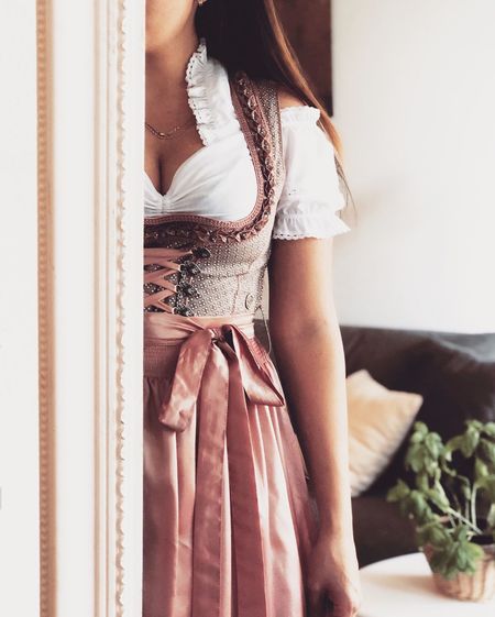 Midsection of woman wearing traditional clothing while standing at home
