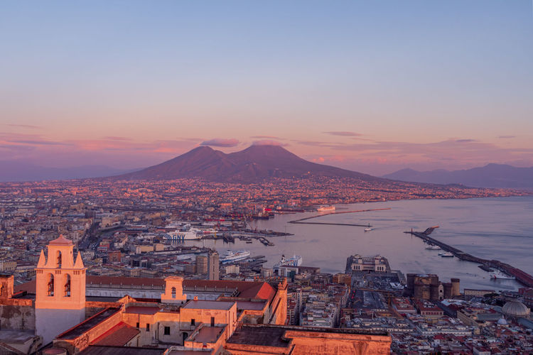 Naples during a pinky sunset, in the backgroung vesuvius