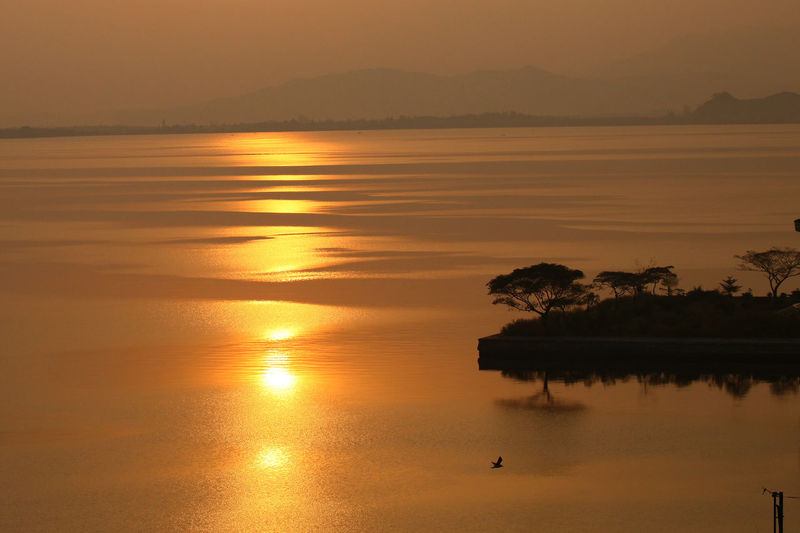 Scenic view of lake against orange sky. sunset in north korea.