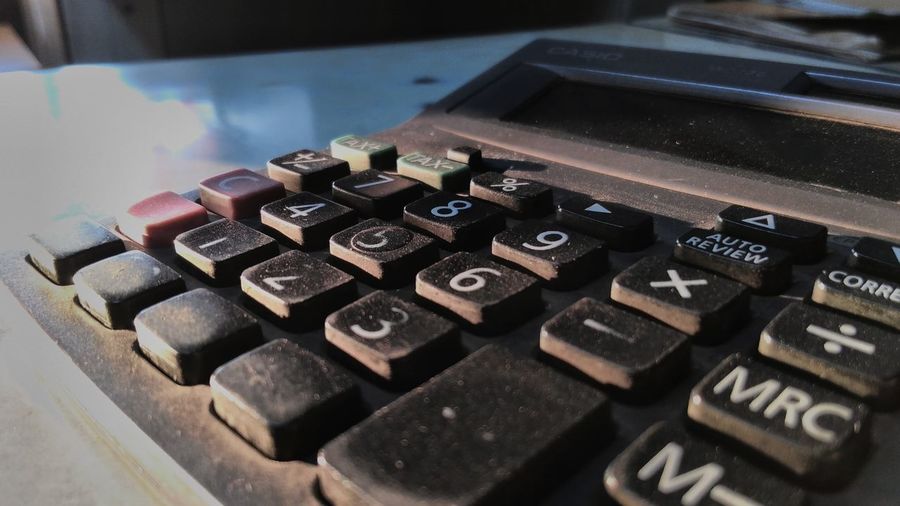 Close-up of old dirty calculator on table