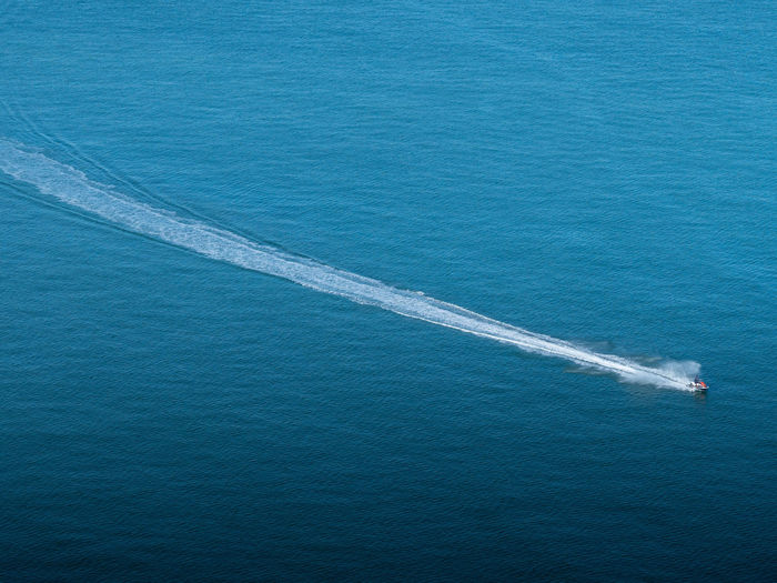 High angle view of sea against blue sky