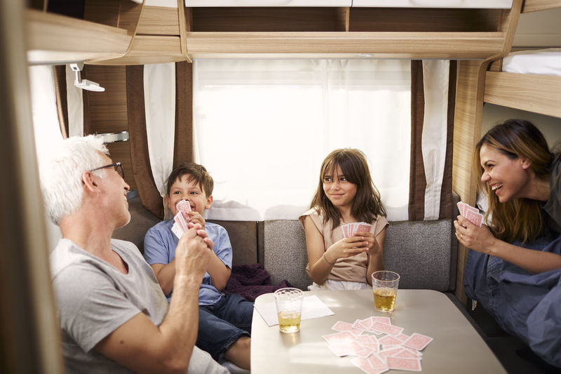 Family playing cards in camper van