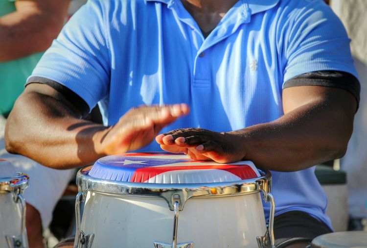 Cropped image of man playing bongo