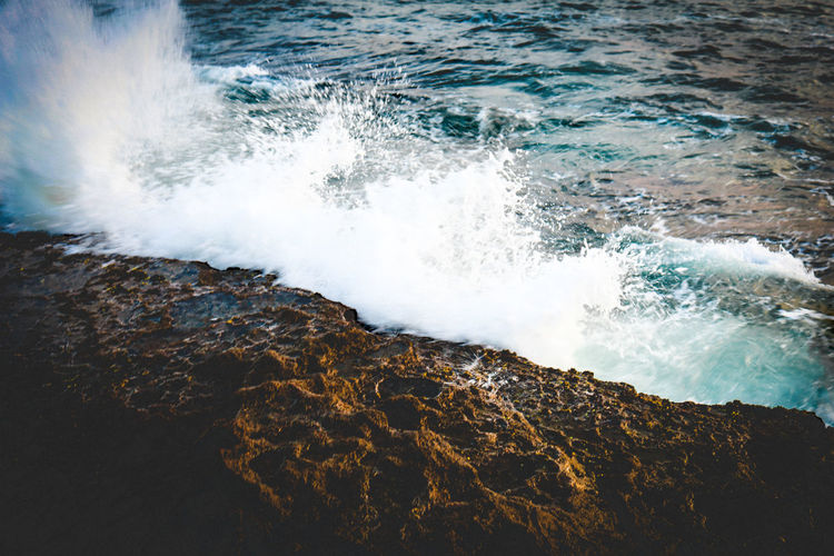 Waves splashing on rocks at shore