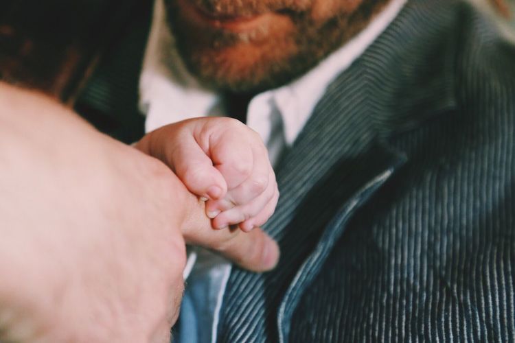Close-up of man and baby hands
