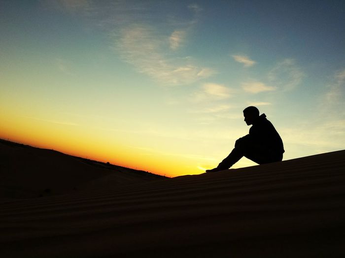 Silhouette man against sky during sunset