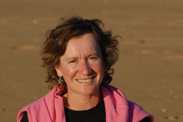 Portrait of mature woman smiling at beach