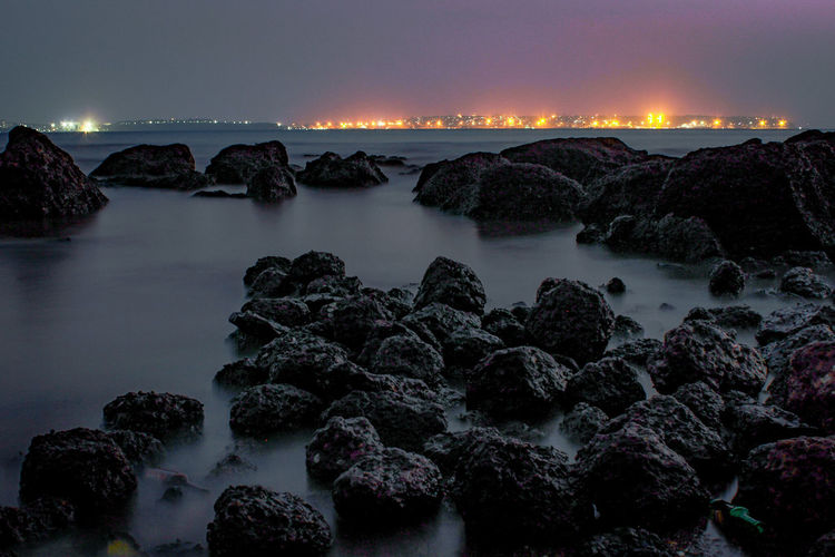 Rocks at beach during night