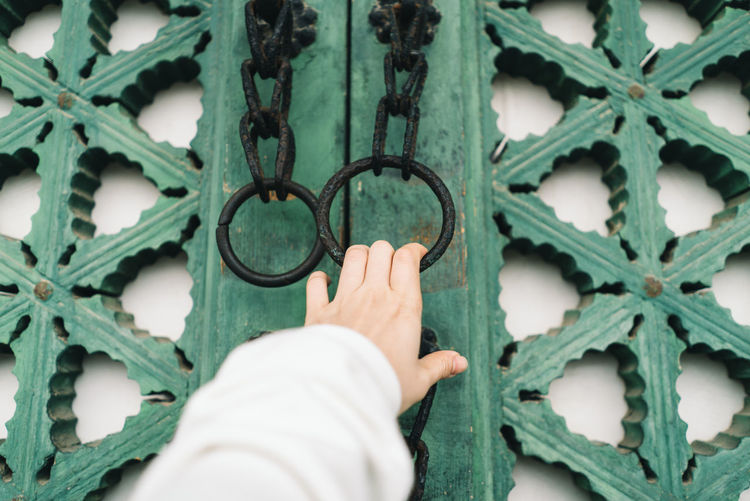 Cropped hand holding door knocker