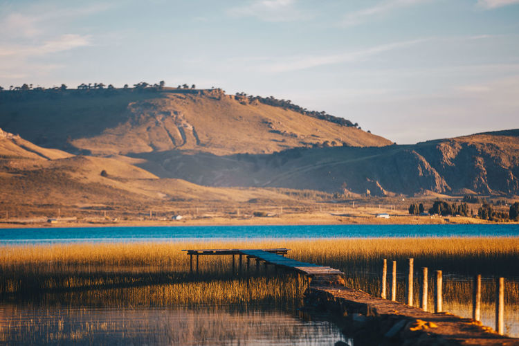 Scenic view of lake and mountains against sky