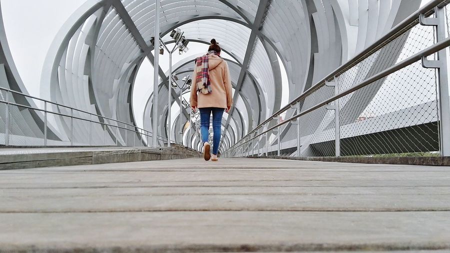 Surface level of woman walking on arganzuela footbridge