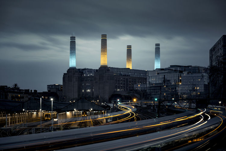 Trains passing before battersea power station in blue hour