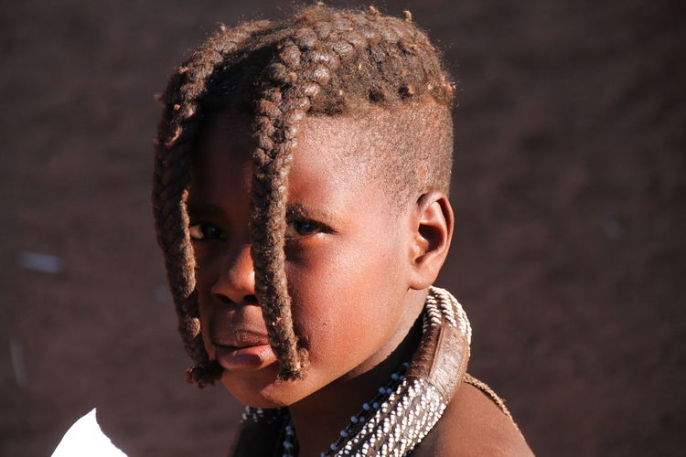 Close-up portrait of girl with dreadlocks