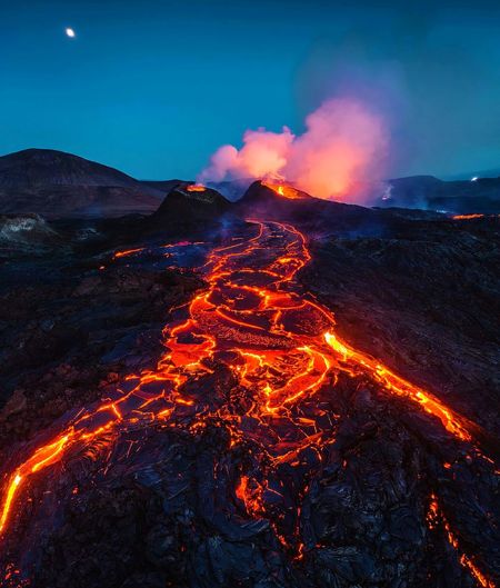 Light trails on illuminated mountain at night