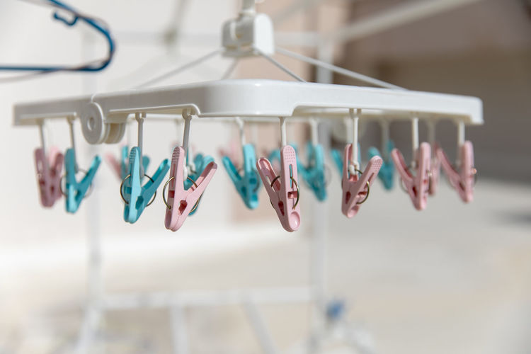 Close-up of clothespins hanging on rack