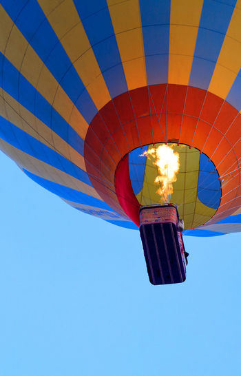Flying in a hot air balloon, the flame of the burner fire heats the air, raising the balloon.