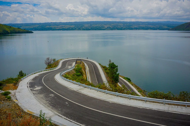 High angle view of road by sea against sky