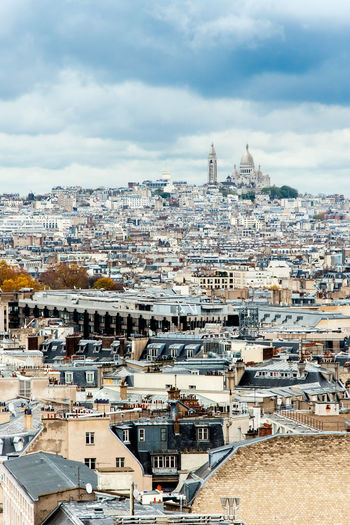 Cityscape against cloudy sky