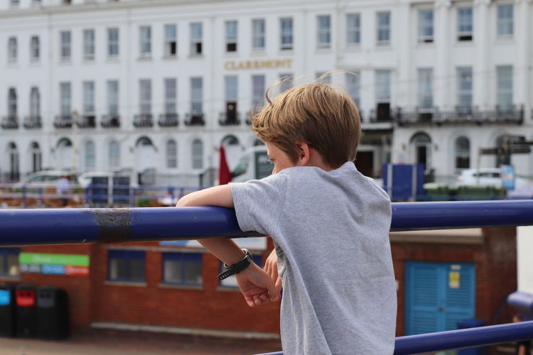 Boy leaning on railing