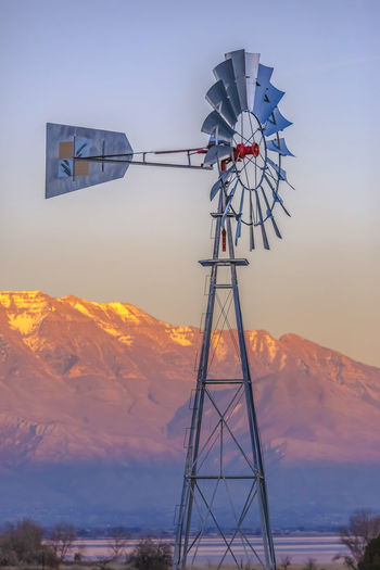 Windmill and mountain against clear sky