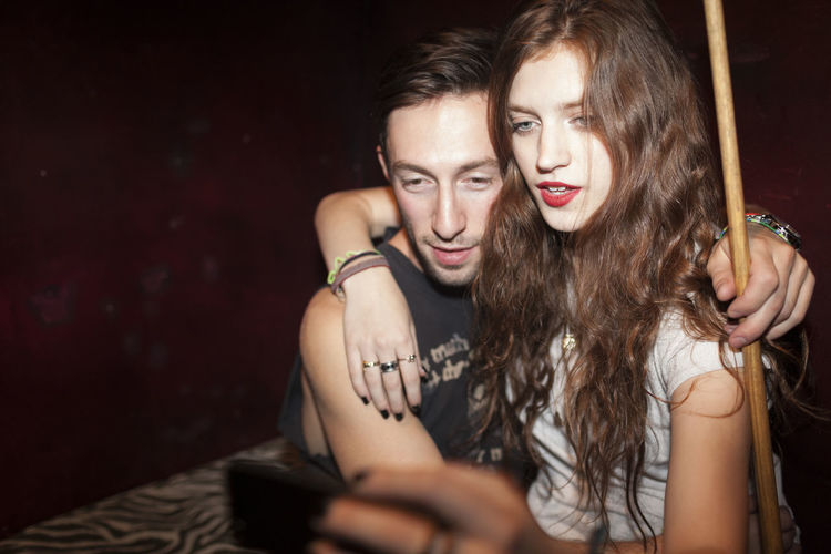 Young couple taking selfies on a cell phone