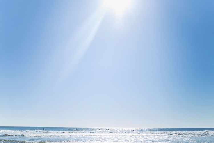 Scenic view of sea against clear sky on sunny day