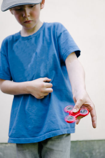 Boy playing with fidget spinner gadget toy