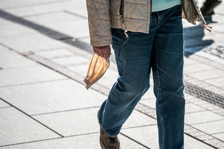 Low section of man walking on footpath