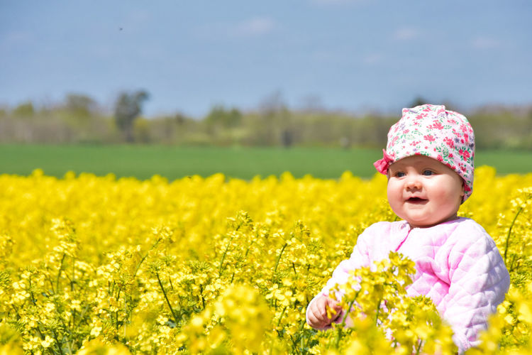 Portrait of cute girl standing on field