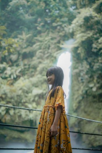 Happiness an asian little girl enjoys the beauty of curug sawer situ gunung waterfall