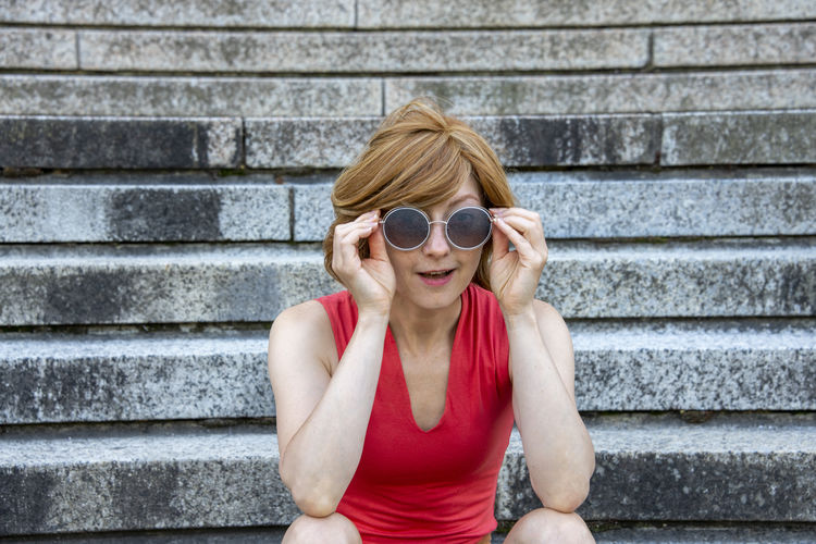 Young european woman with sunglasses and looking at the camera