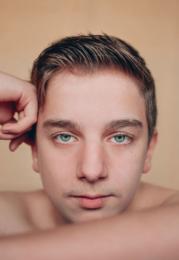 Close-up portrait of shirtless young man