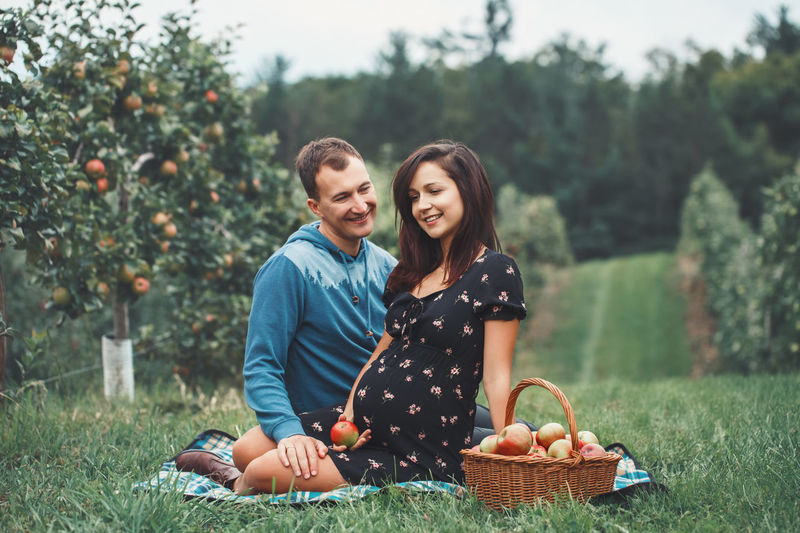 Man sitting with pregnant woman at farm
