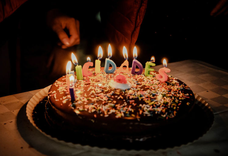 Lit candles on birthday cake