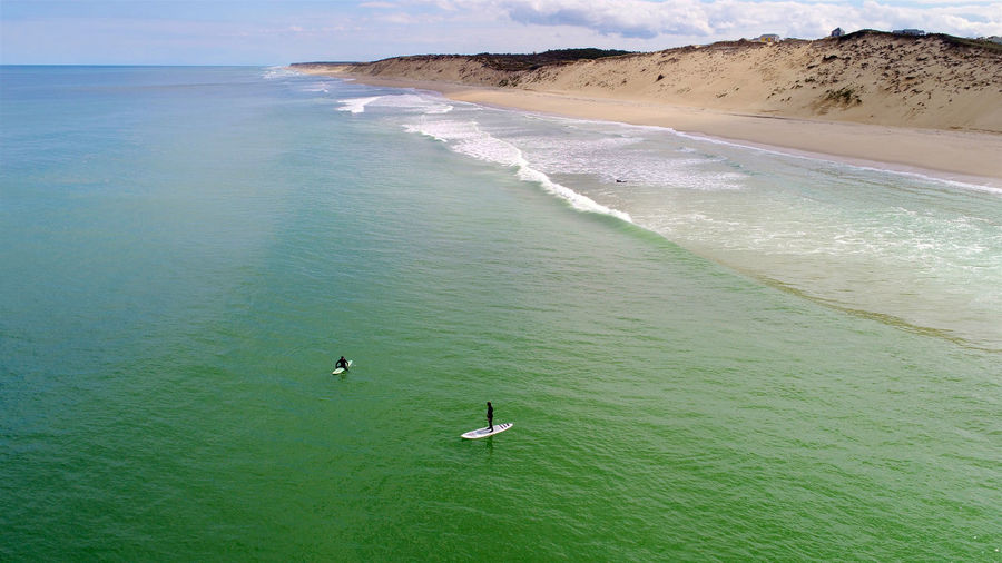 High angle view of people paddleboarding in sea