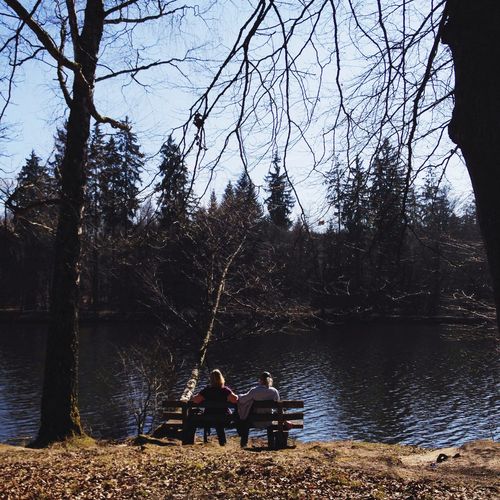 Couple sitting on lakeshore