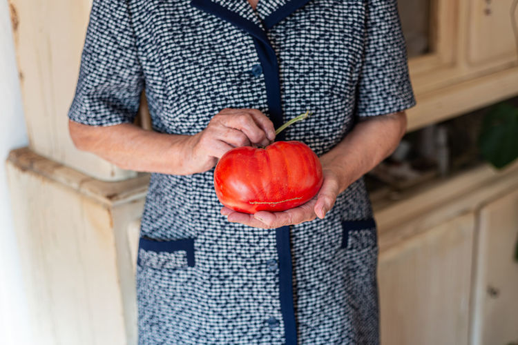 Grandma holding huge tomato
