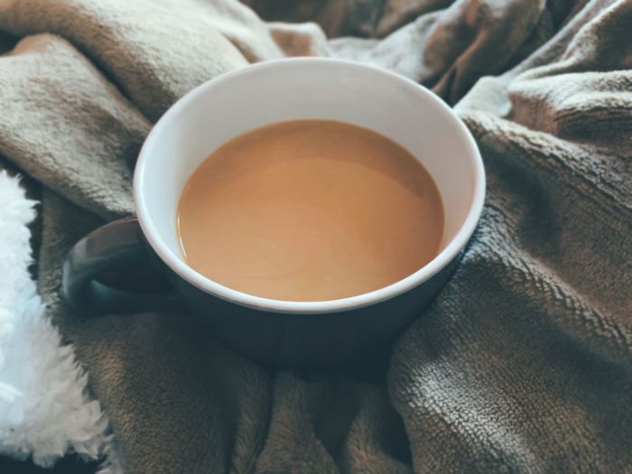 High angle view of tea cup on bed