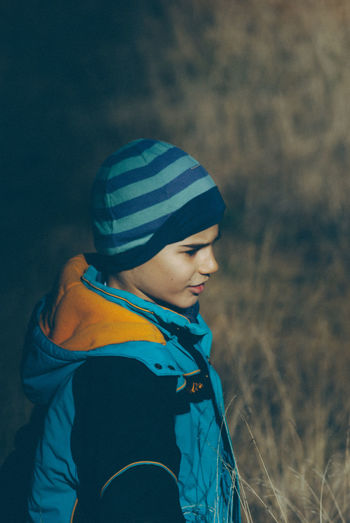Boy on grassy field during winter