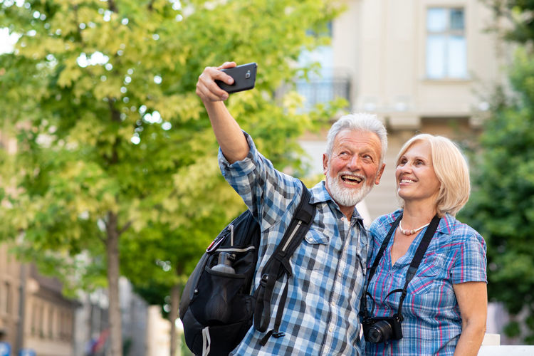 Portrait of senior couple taking selfie with mobile phone